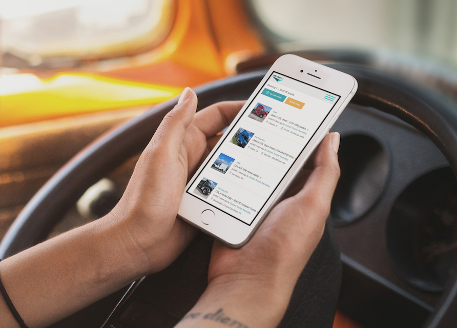 Driver job app on phone in truck