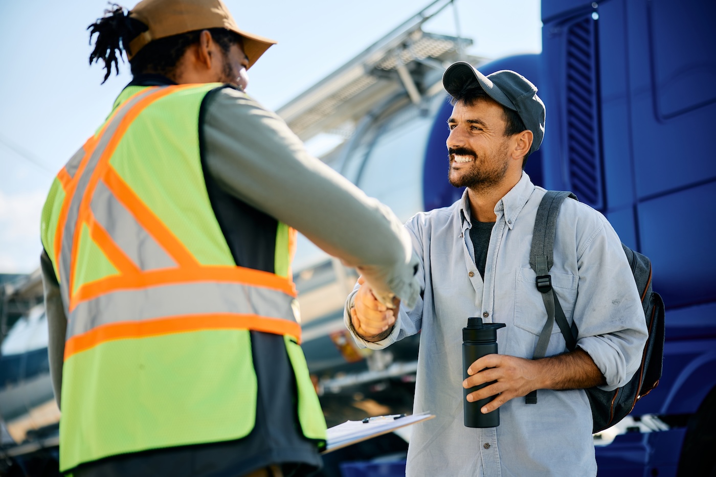 Happy truck driver greeting freight transportation